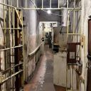 Inside the KGB headquarters in Riga. A corridor in the cell block with bars and locked doors.